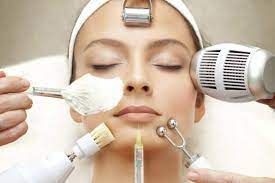 A woman is getting a facial treatment at a spa.