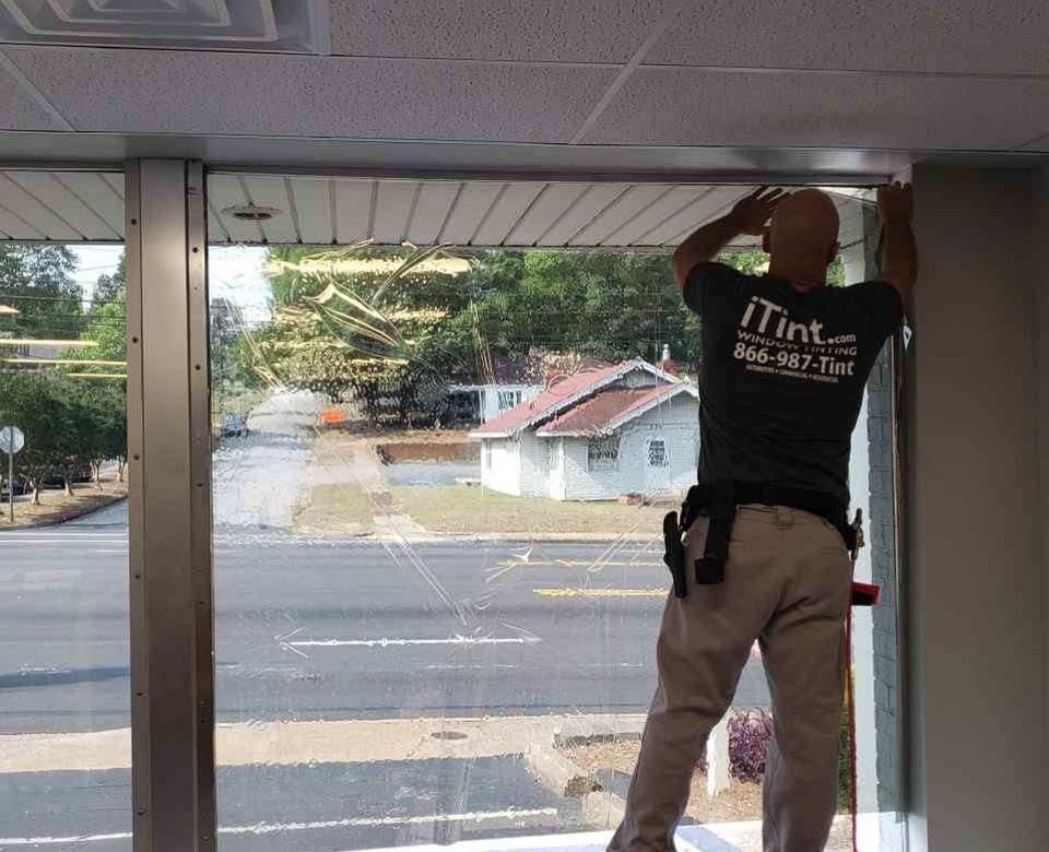 Man Installing a Tinted Film — Greenville, SC — iTint