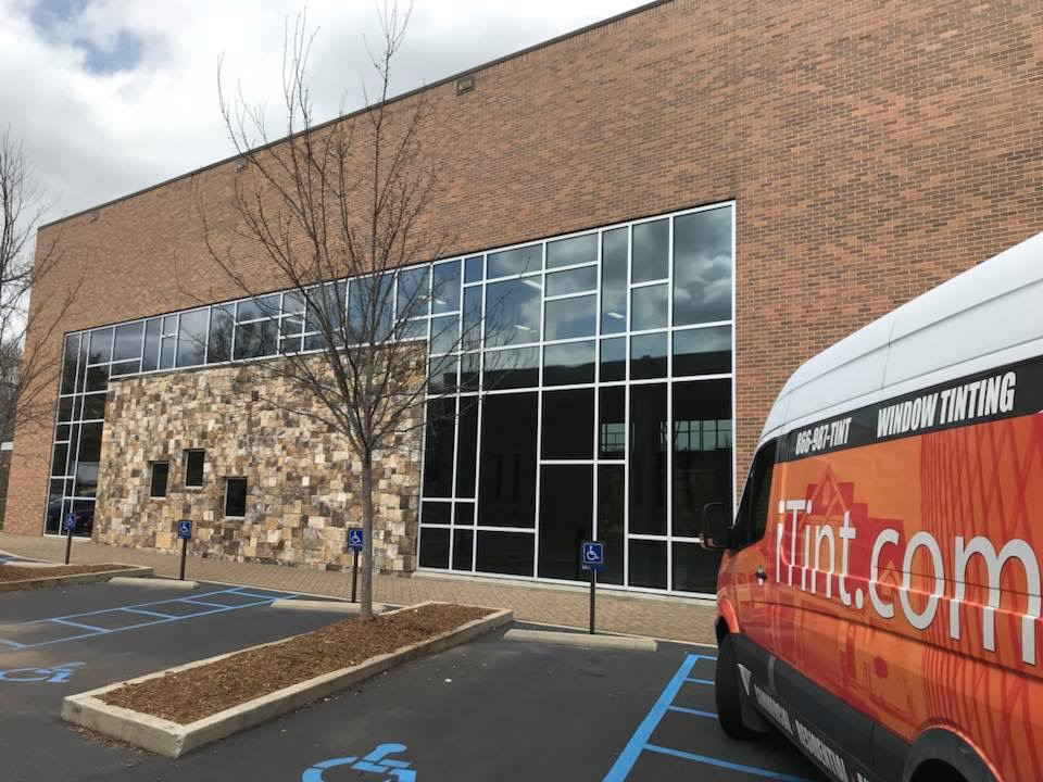A Tinted Windows of a Building With iTint Service Truck — Greenville, SC — iTint