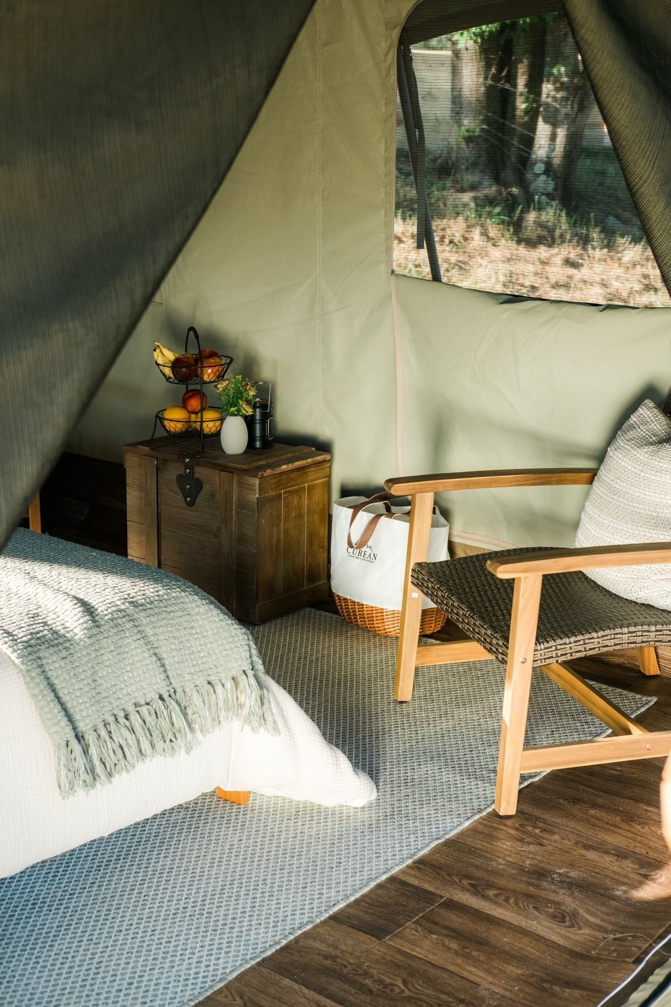 There is a bed and a chair in the tent.