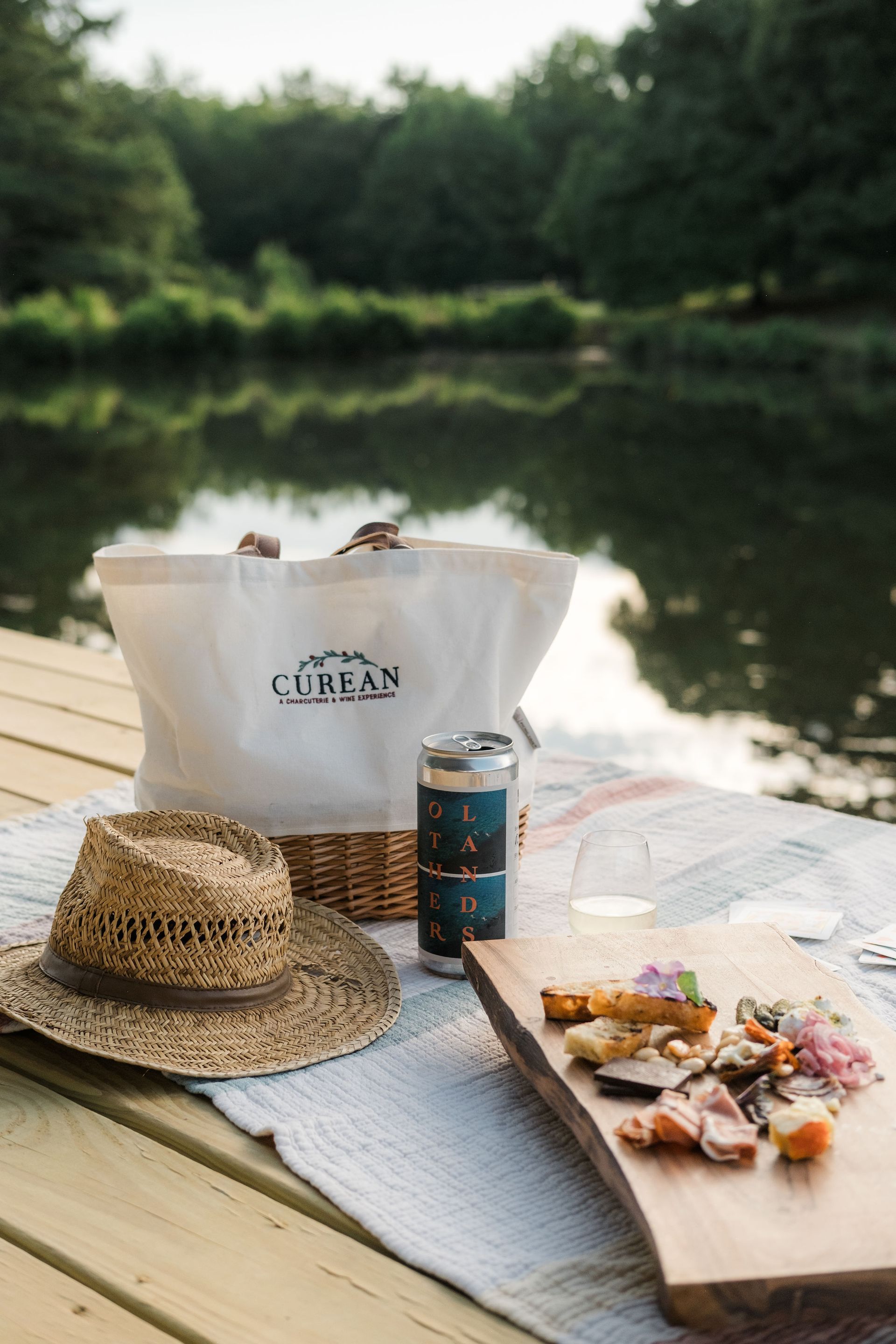 A picnic is being held on a dock near a lake.