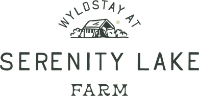 The serenity lake farm logo is a black and white logo with a house in the background.