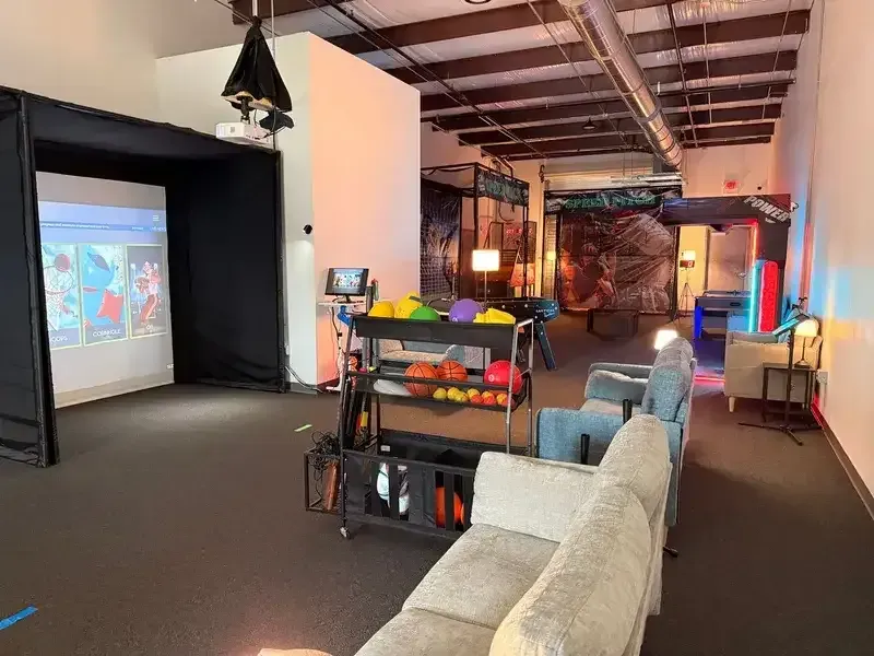 Indoor gaming lounge with arcade and seating area