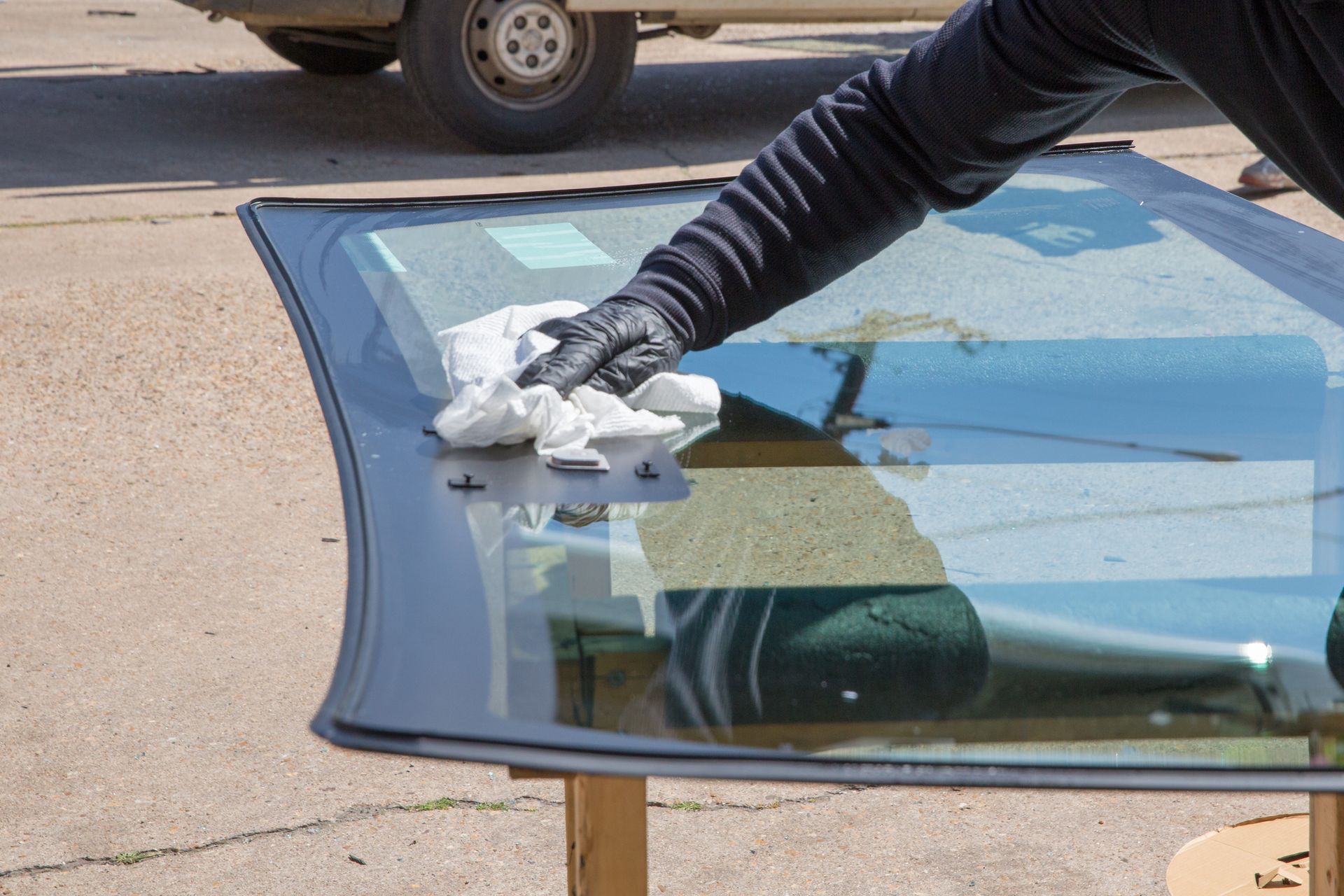 A person is cleaning a windshield with a cloth - Drummond, MT - Big Sky Auto Glass and Screens