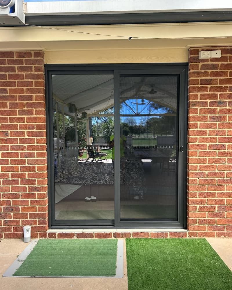 Sliding Glass Door With Dark Frame — Ingrams Installations in Wagga Wagga, NSW