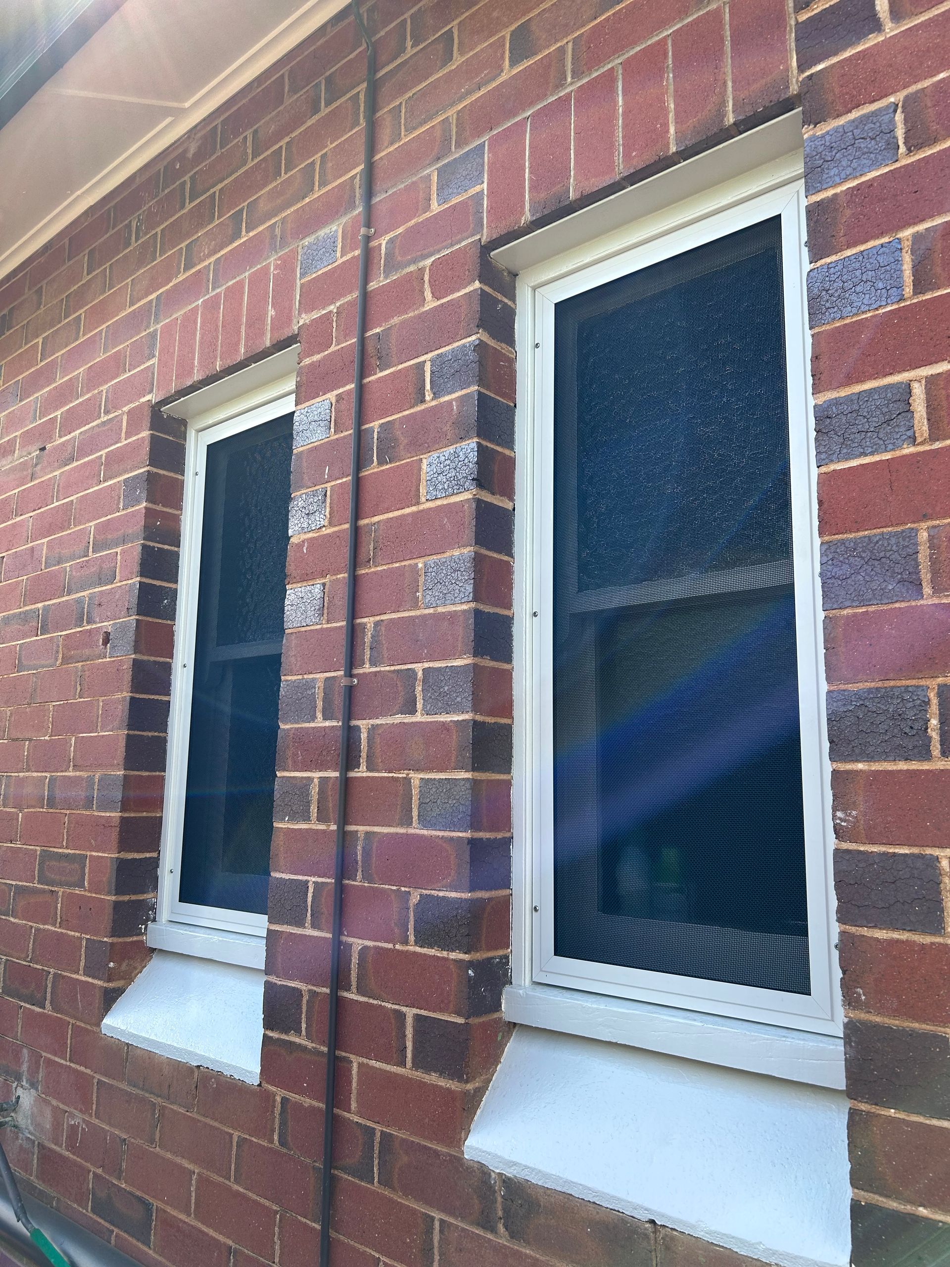 A Security Screen Over A Window On A Brick House  — Ingrams Installations in Wagga Wagga, NSW