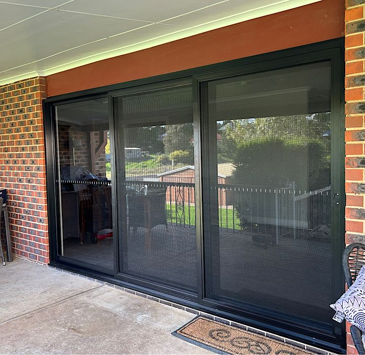 Modern Building With Grey Corrugated Walls and Doors — Ingrams Installations in Wagga Wagga, NSW