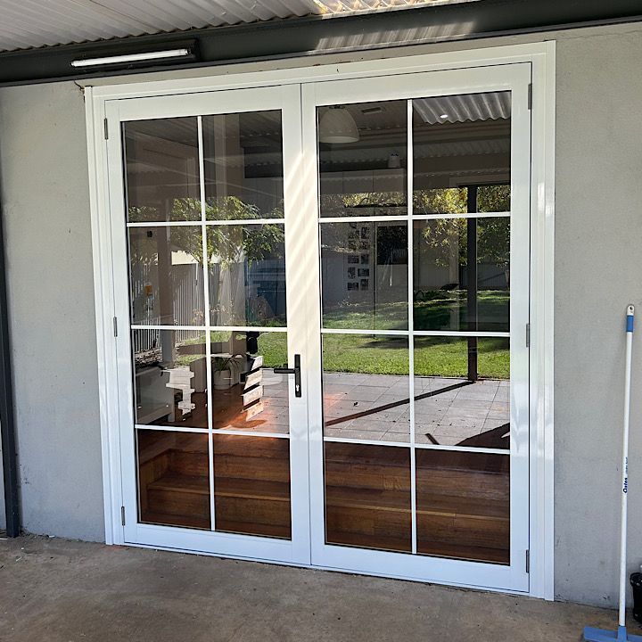 A Glass Door With A White Frame — Ingrams Installations in Wagga Wagga, NSW