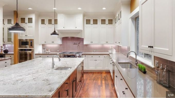 A kitchen with white cabinets and granite counter tops