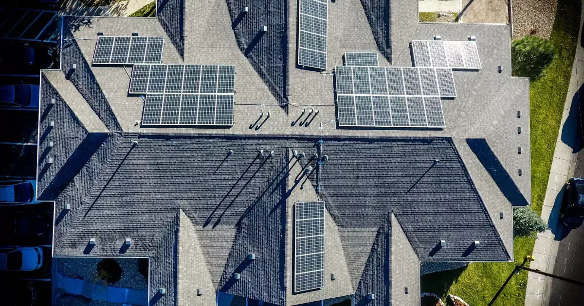Aerial view of residential rooftop solar panels showing the benefits of solar energy for reducing electricity costs and increasing property value