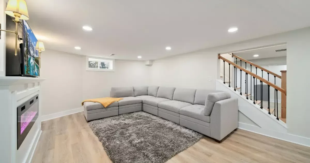 Basement living area with soft lighting and layered textures
