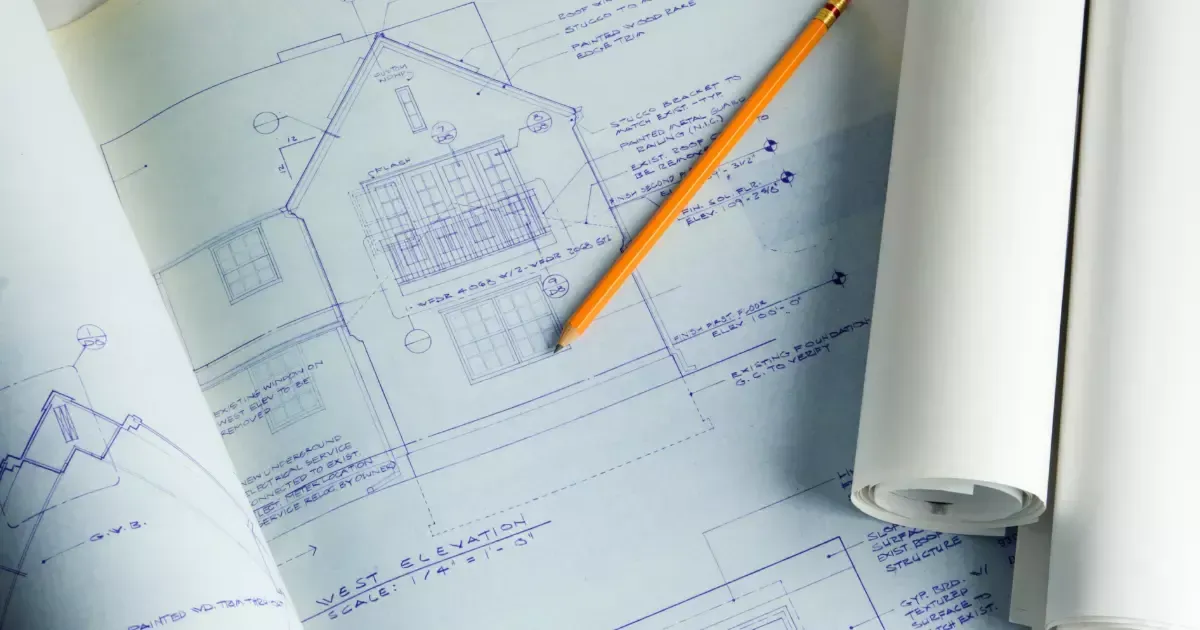 Blueprint showing a detailed home addition plan with a pencil on top