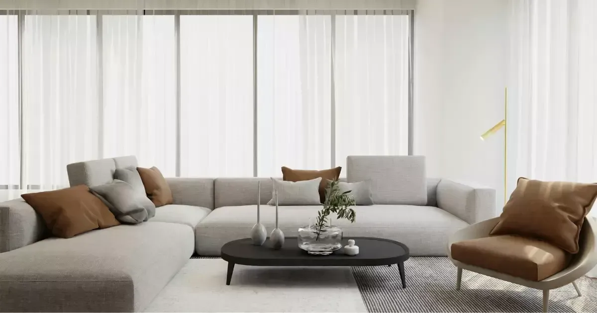 Bright open space with a large gray sectional sofa, accent pillows, and a sleek black coffee table, reflecting trending living room design ideas for comfort and style