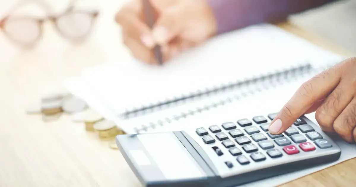 Budgeting a home addition plan using a calculator and notebook