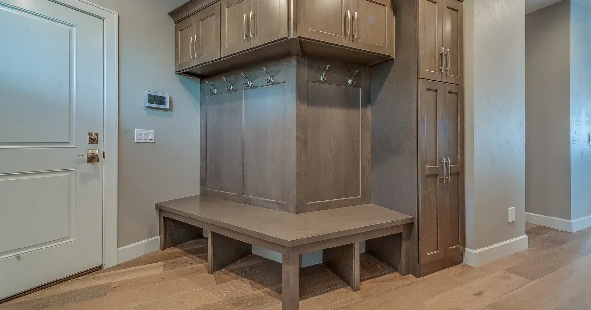 Built-in wood storage bench and cabinets showcasing practical mudroom ideas