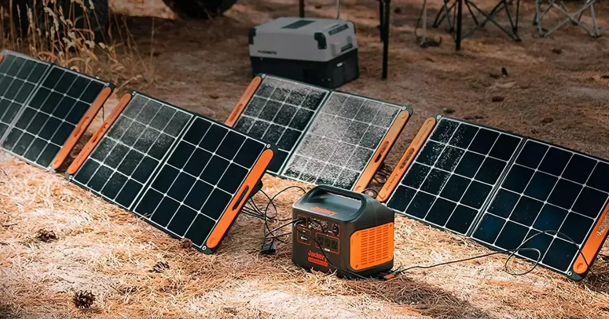 Camping setup with solar powered generator connected to several foldable solar panels