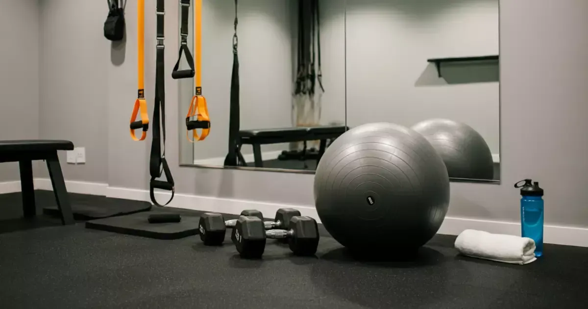 Compact gym space with TRX and dumbbells