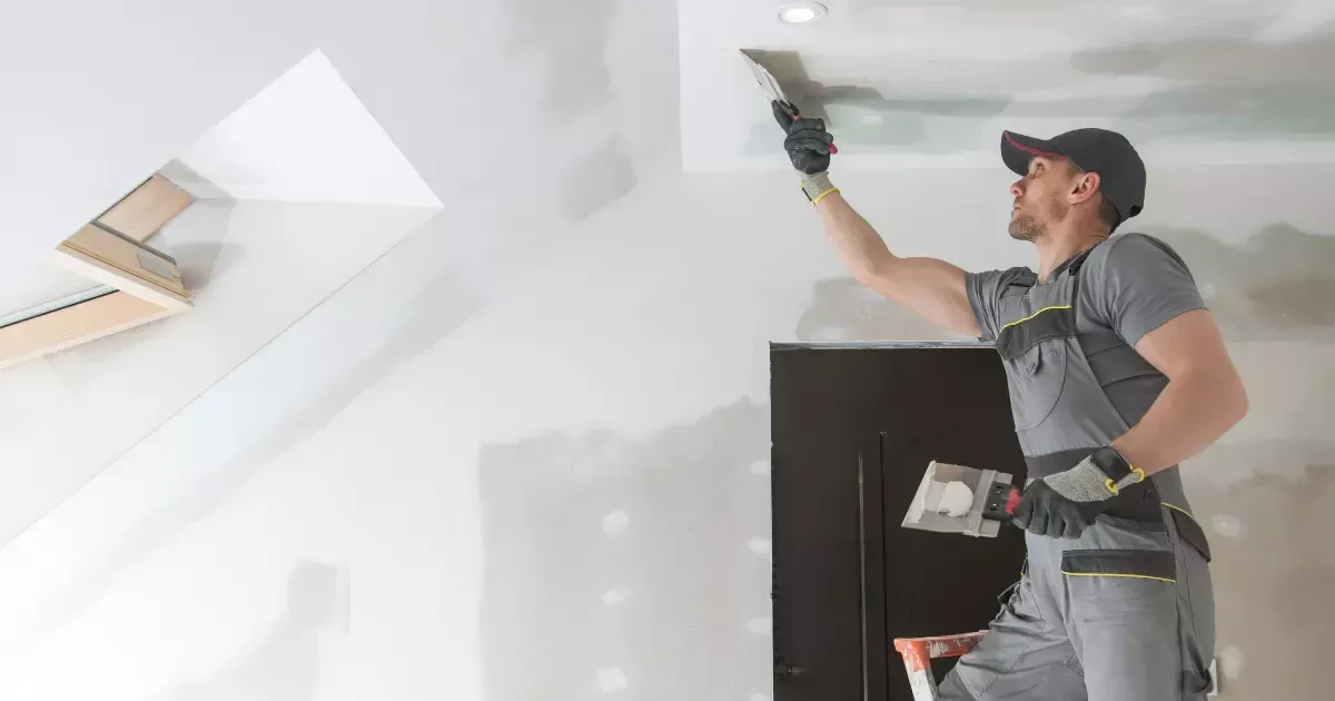Contractor applying drywall for a family-friendly basement finishing option