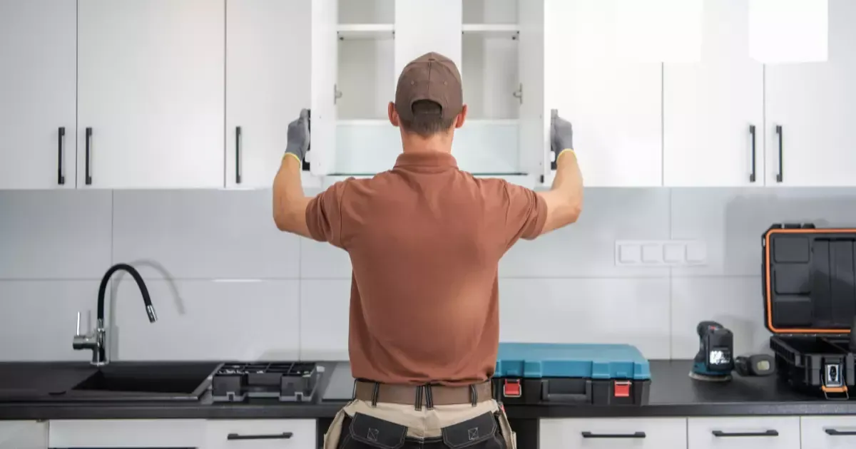 Contractor working on a kitchen upgrade affecting home remodeling cost