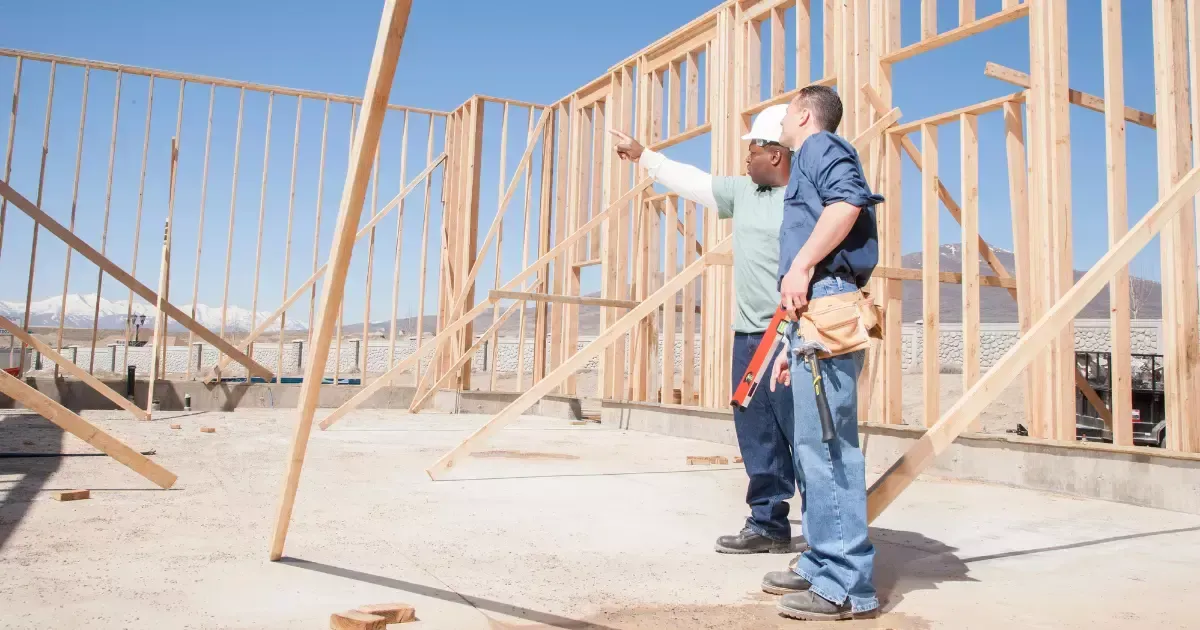 Contractors planning and inspecting framing work for new home construction near me