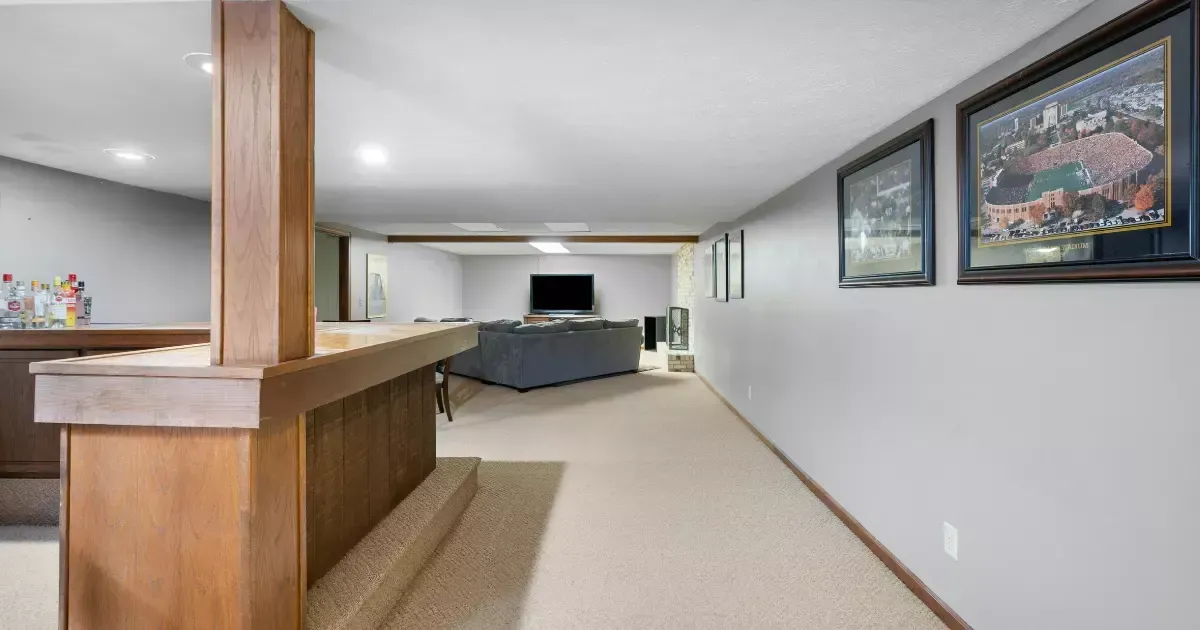 A long hallway leads to a living room in a house.