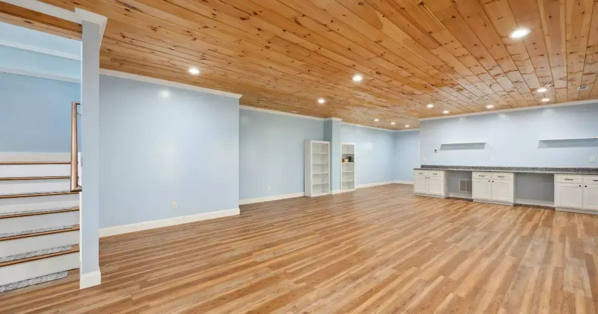 Finished basement with wood ceiling and vinyl floors