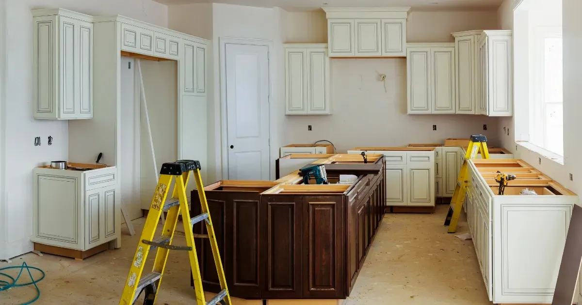 Kitchen renovation in progress with cabinets being installed by a kitchen addition builder