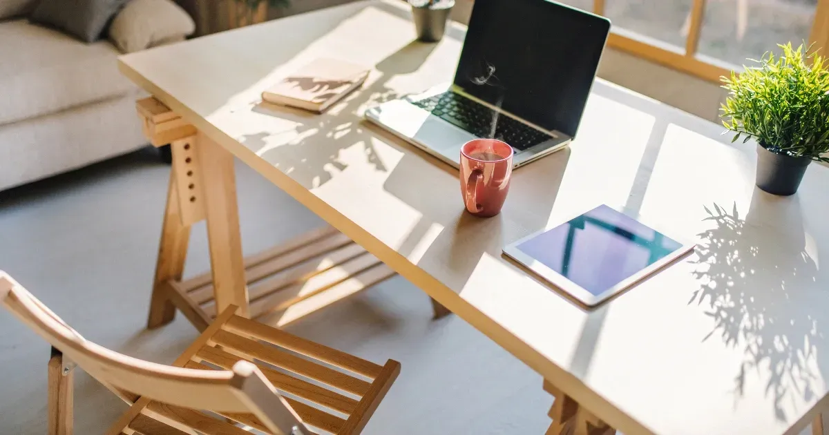 Minimalist workspace with natural light and plants, perfect for home office design inspiration