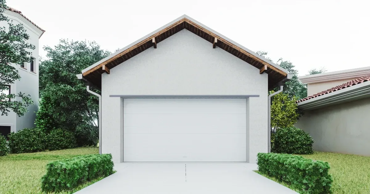 Modern single garage apartment with white exterior and green surroundings