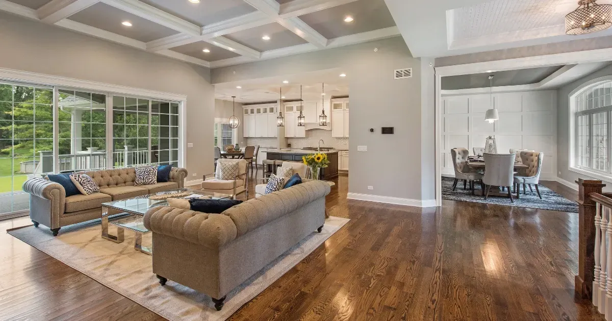 Open floor plan ideas with a spacious living area, coffered ceilings, and a connected dining and kitchen space