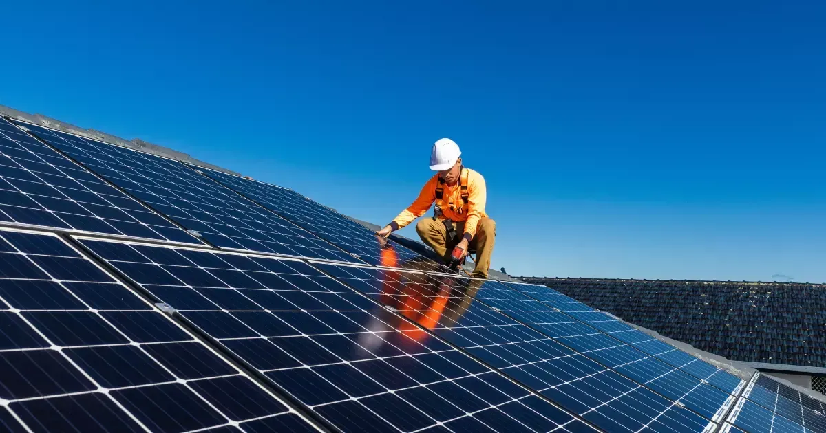 Professional performing rooftop solar panel maintenance