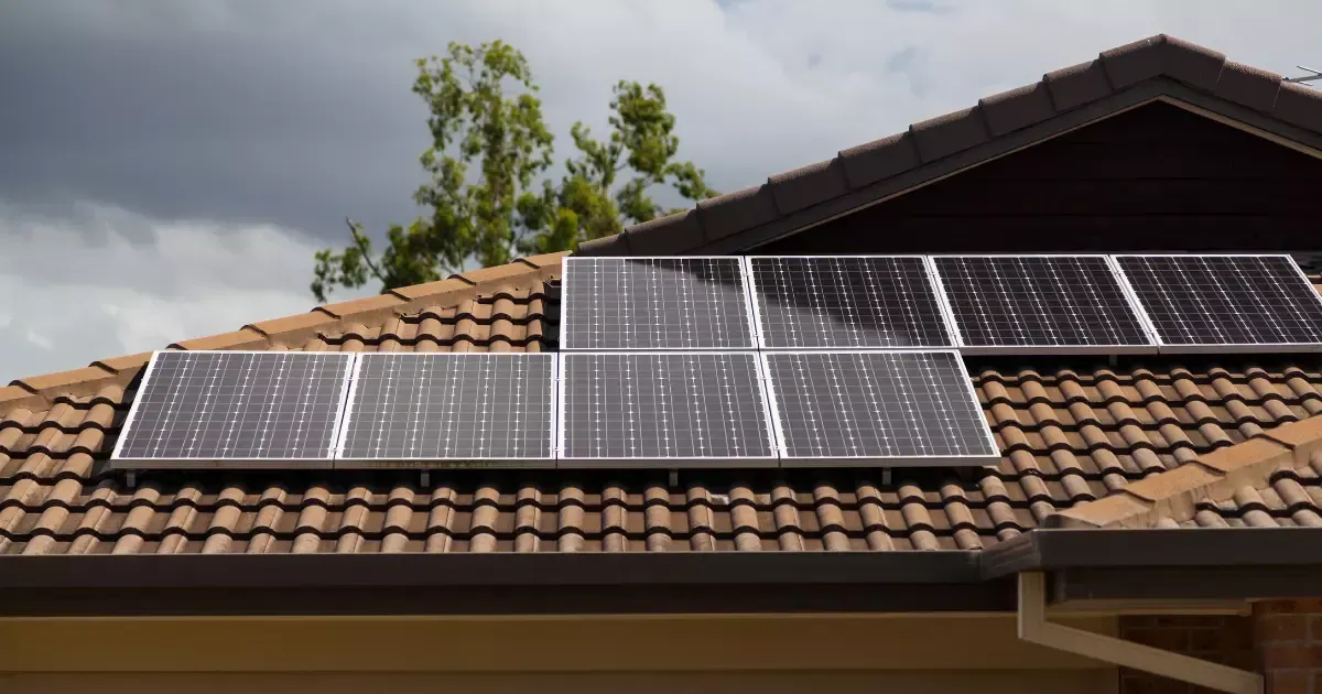Residential home with solar panels for basement placed on a pitched roof to support lower-level energy needs