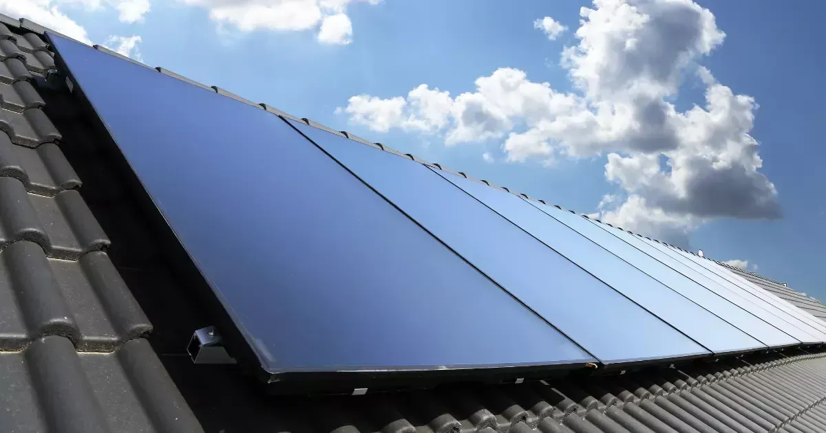 Sleek solar panels for basement installed on a tiled rooftop, capturing clean energy under a sunny sky