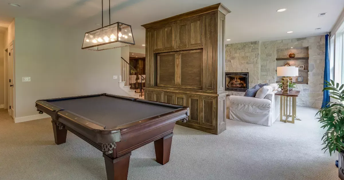 Stylish basement game room with pool table and cozy seating