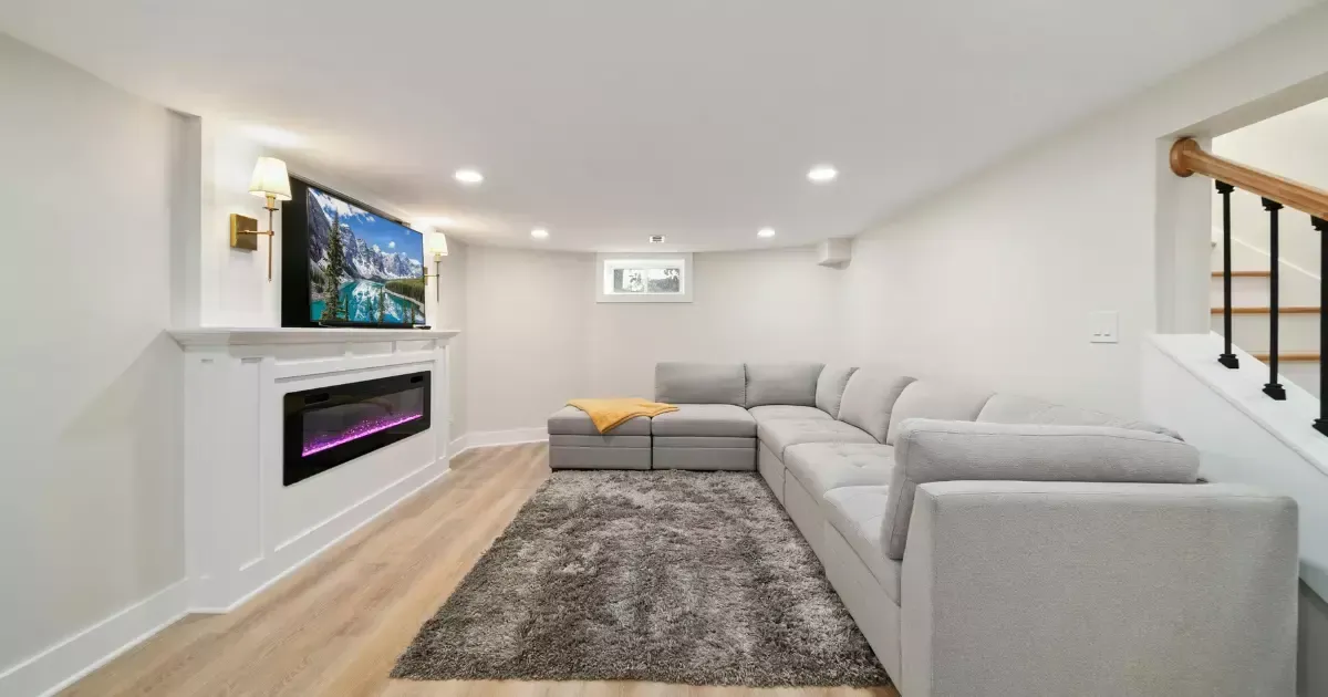 Stylish basement with fireplace and gray sectional
