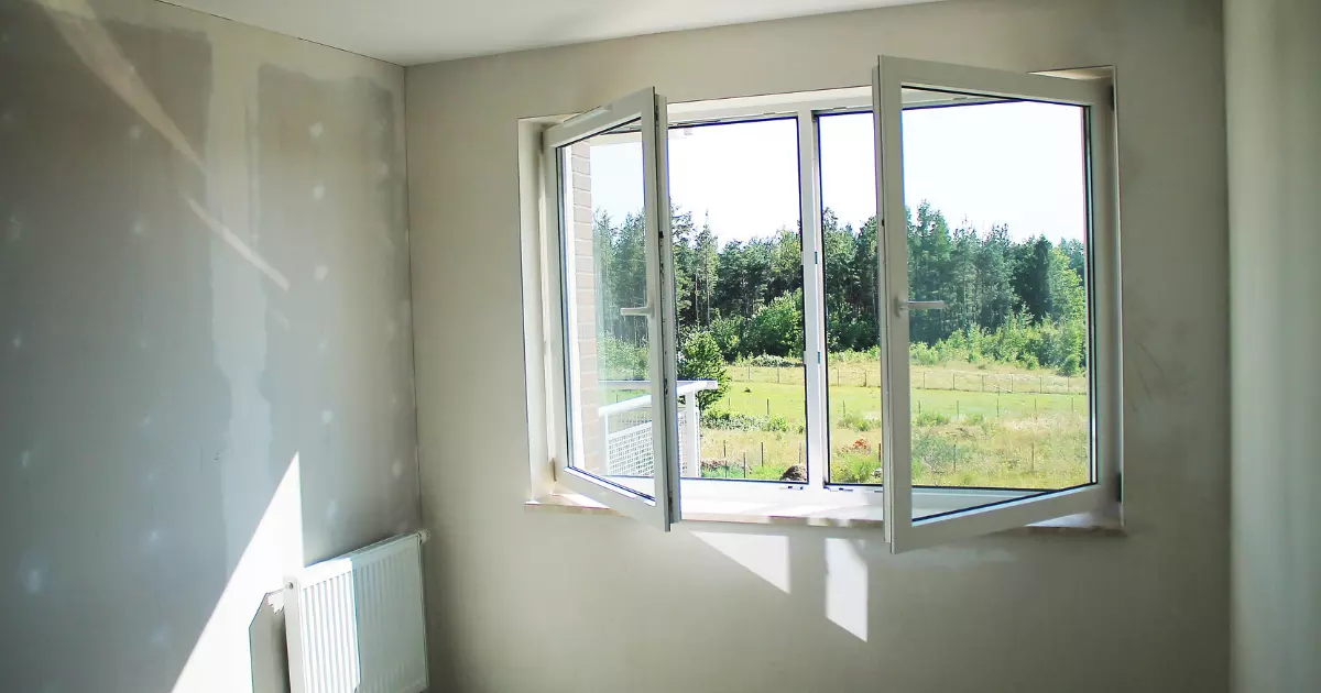 Unfinished room with sunlight through open glass window