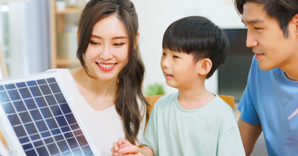 A person and a child looking at a solar panel