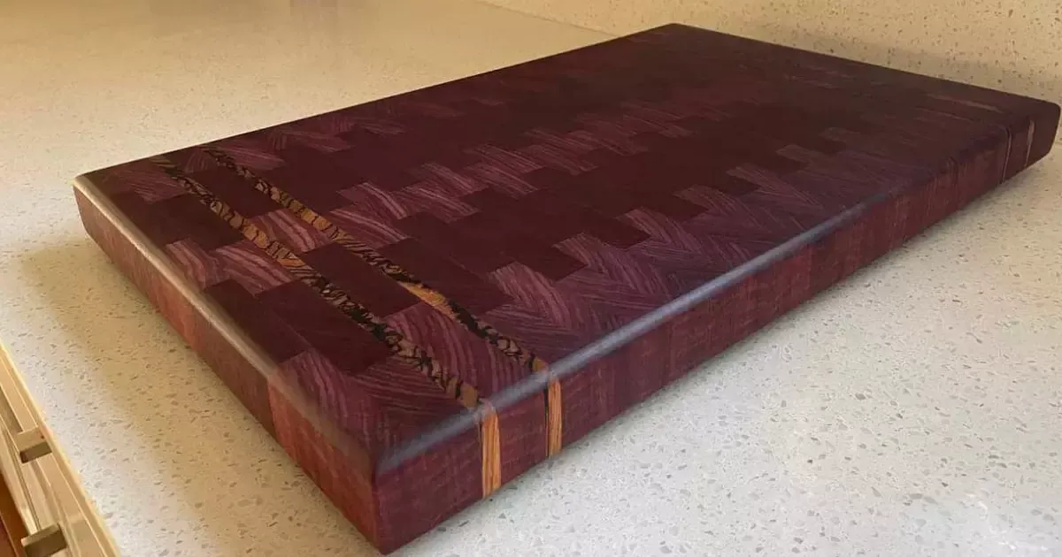 A close up of a chocolate brown wood cutting board