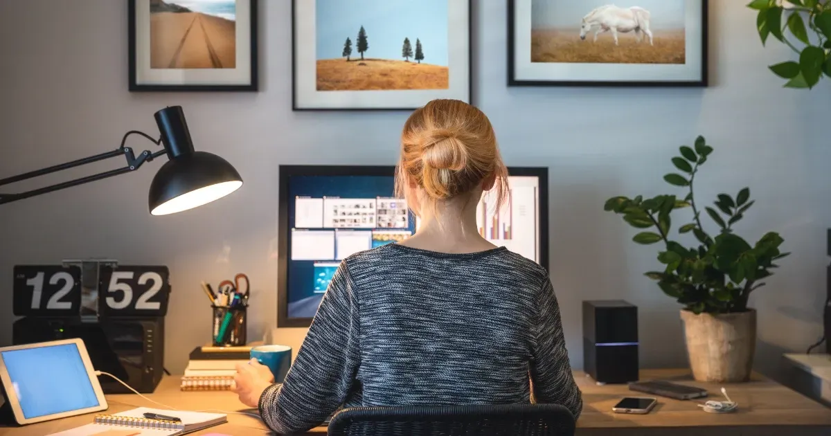 Woman working at computer in a cozy home office design setup