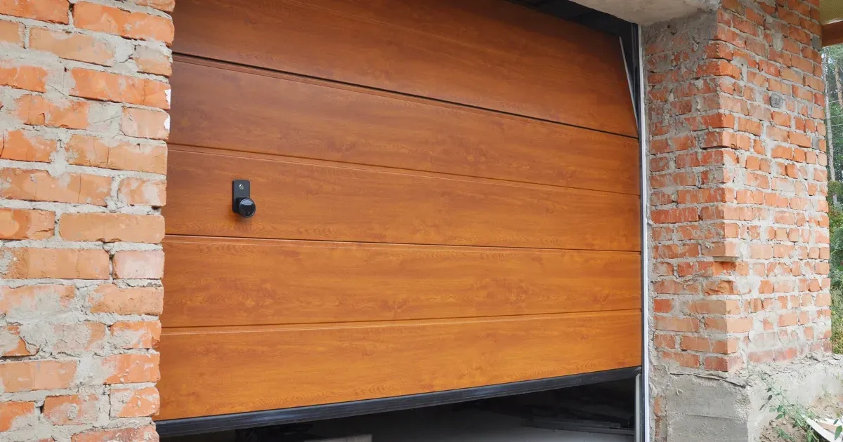Wood-finish garage door highlighting popular modern garage door trends for stylish exteriors