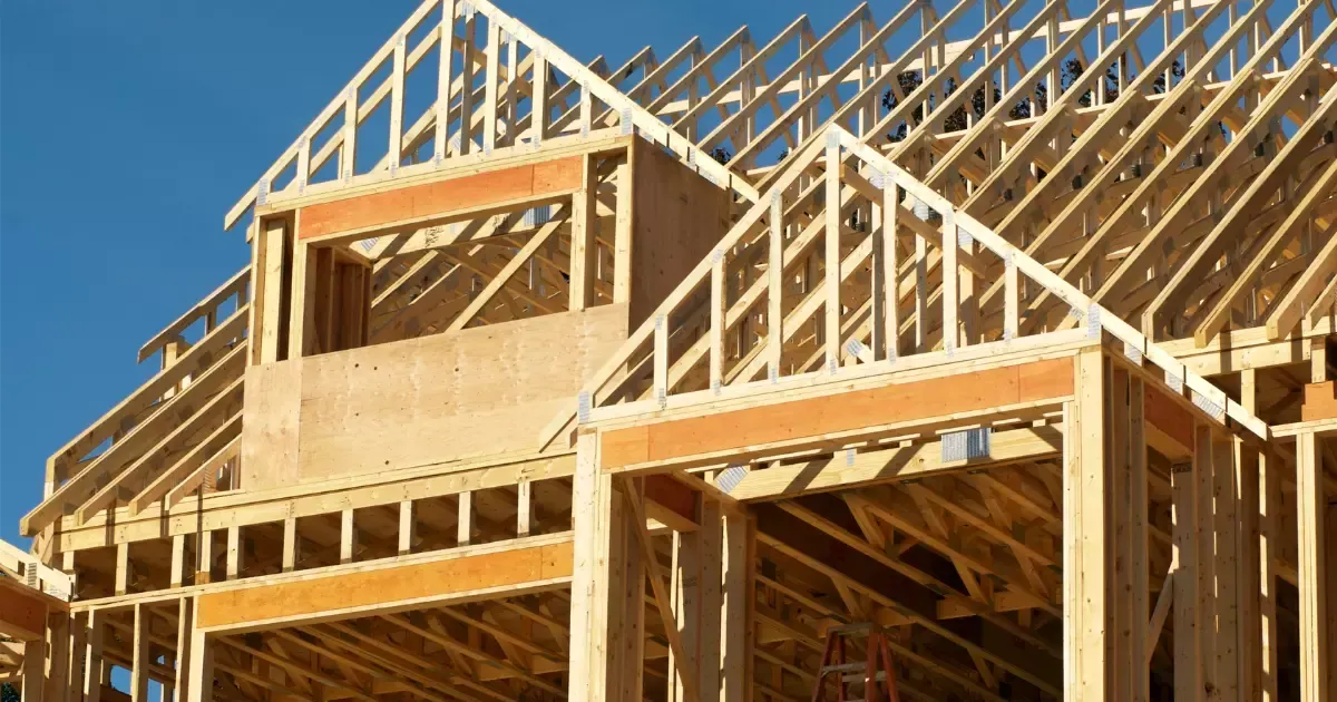 Wooden framing and roof trusses in progress for new home construction near me