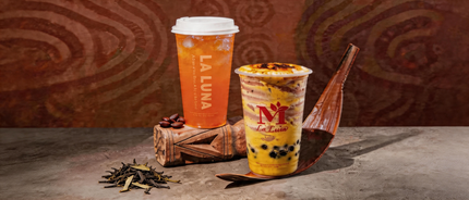 Iced tea drinks with fruit garnish and wafer cones on a rustic table