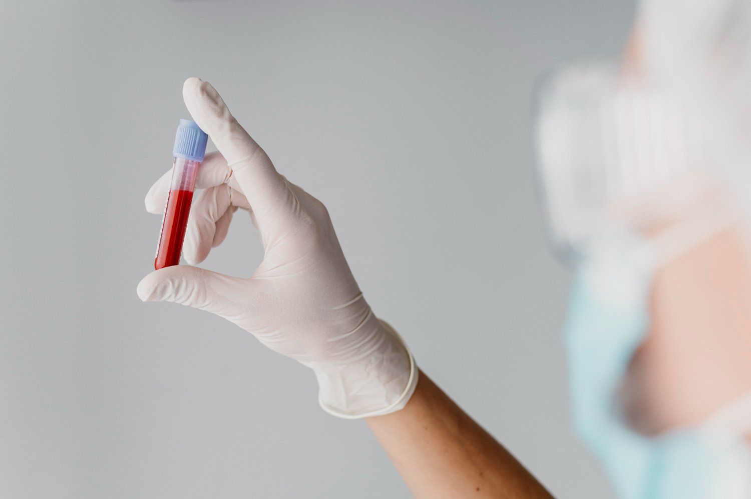 nurse holding vial