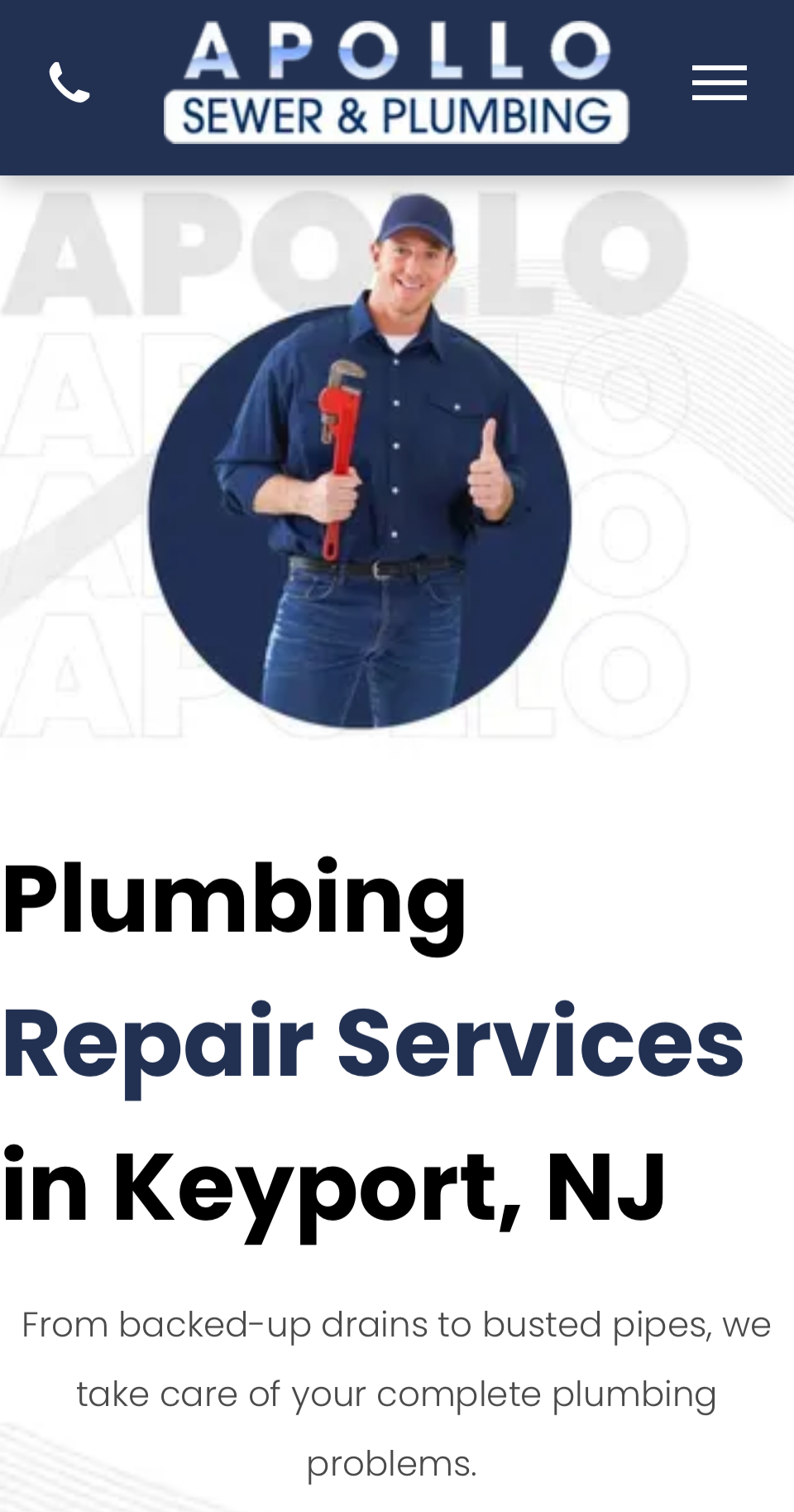 A man is holding a wrench and giving a thumbs up.