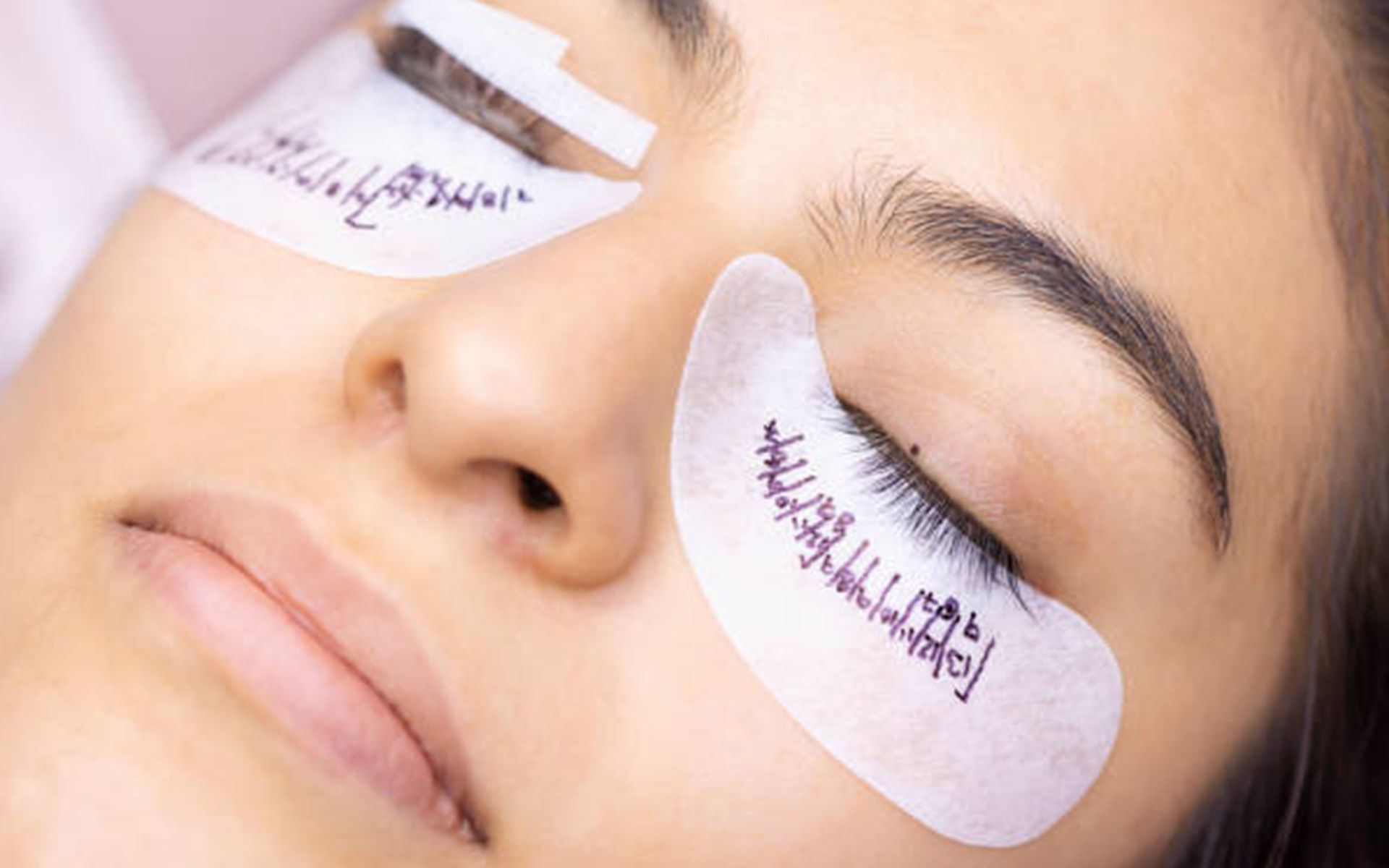 A close up of a woman 's face with eye patches on her eyes.