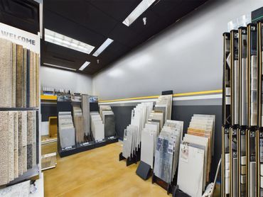 A store filled with lots of tiles and a sign that says welcome