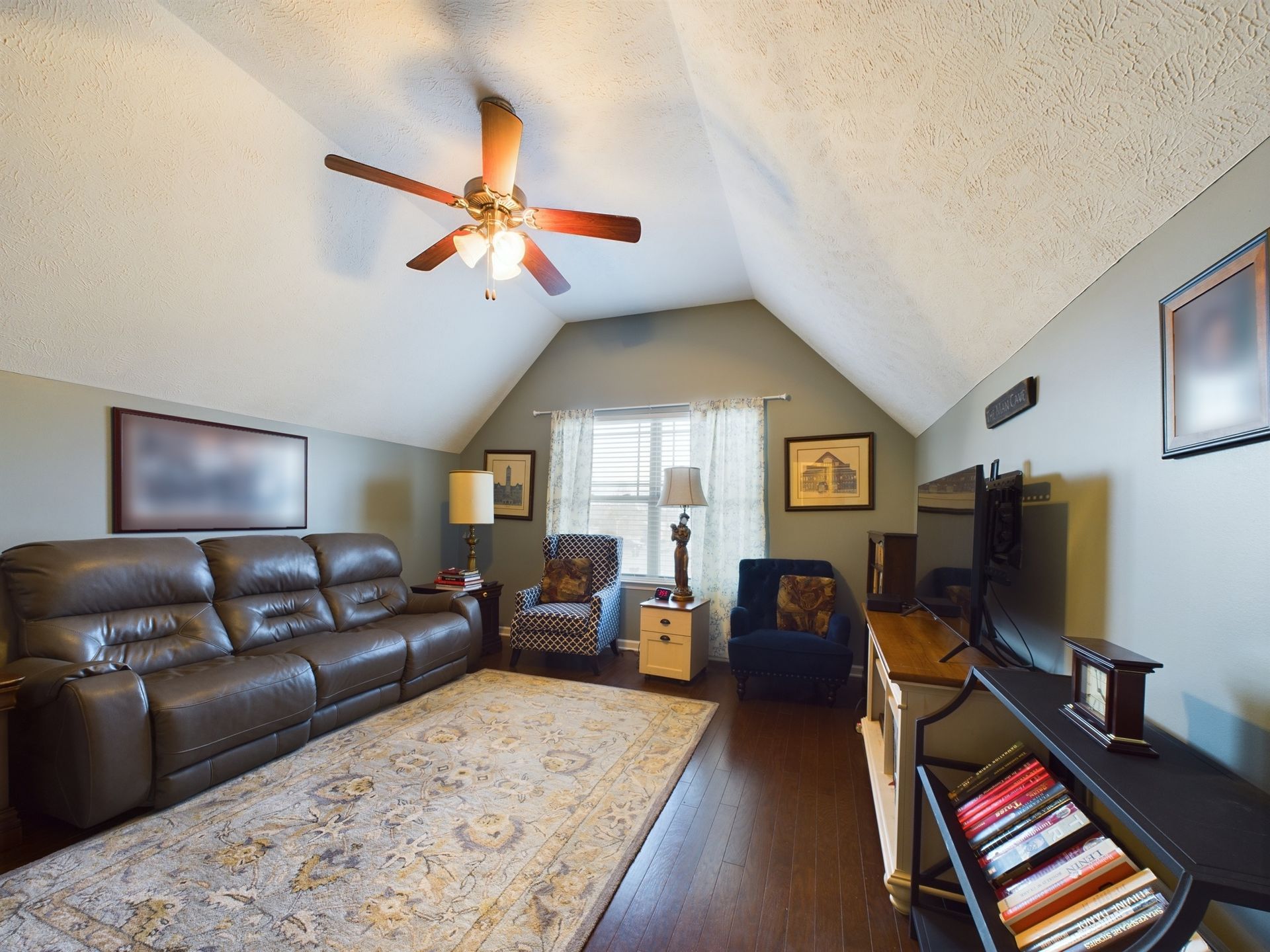 A living room with a ceiling fan and a couch