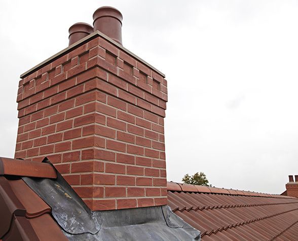 a red brick chimney on top of a roof