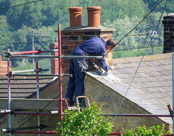a man is working on the roof of a building