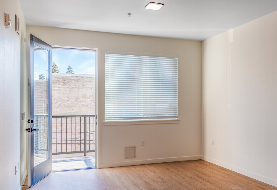 Photo of a living room area with an exit to a balcony
